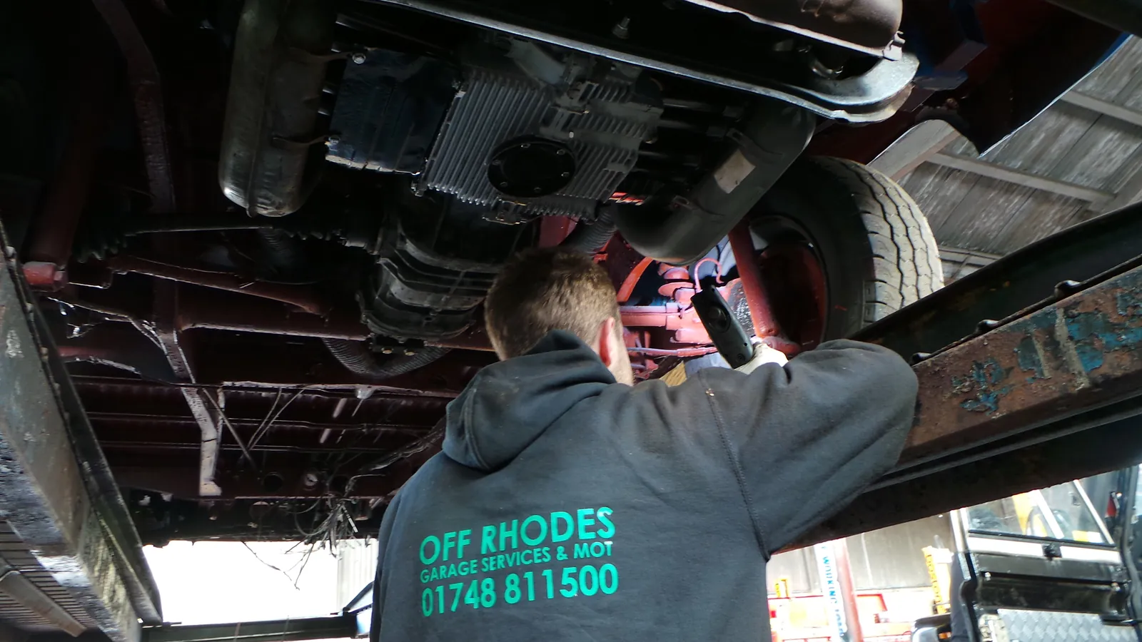 Off Rhodes technician working underneath a car