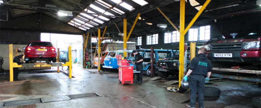 Inside the Off Rhodes workshop with cars up on the lifts