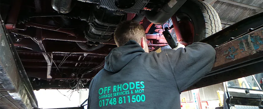 Off Rhodes technician working underneath a car