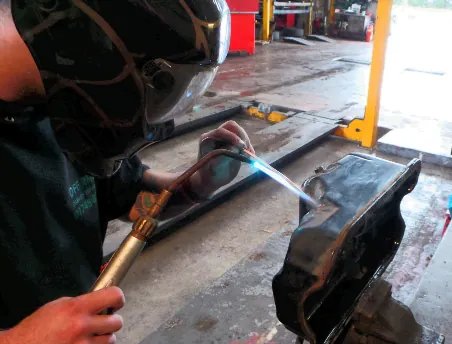 Welding repair being carried out on a vehicle